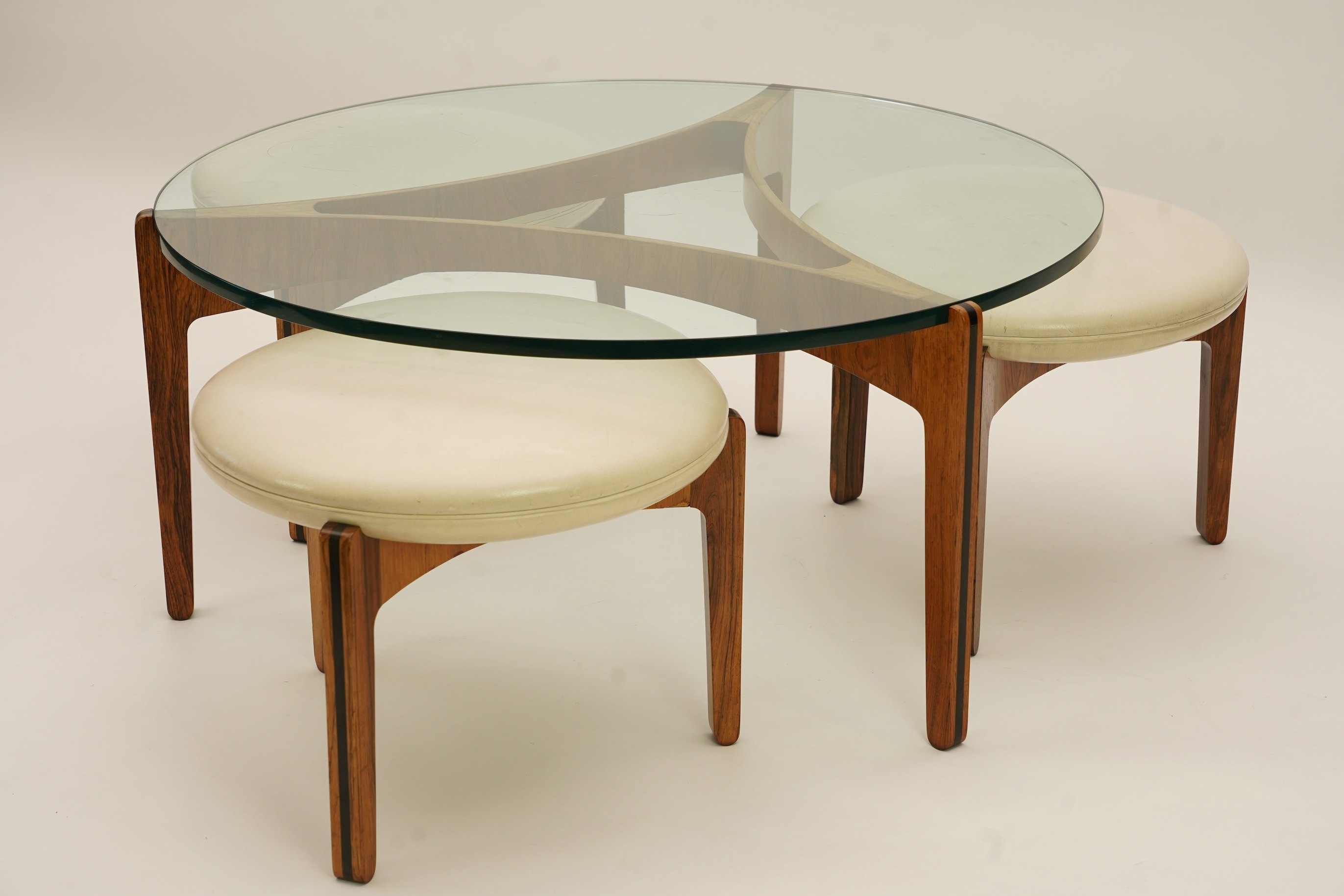 Sven Ellekaer (Danish, 1926-1984) for Christian Linneberg Møbelfabrik: A coffee table and three nesting stools ensuite